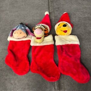 vintage Disney Winnie the Pooh, Tigger, and Eeyore plush Christmas stockings.